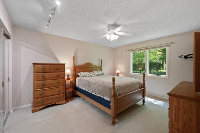 17915 17th Ave N, Plymouth, MN 55447 - bedroom featuring light carpet, baseboards, a textured ceiling, and a ceiling fan