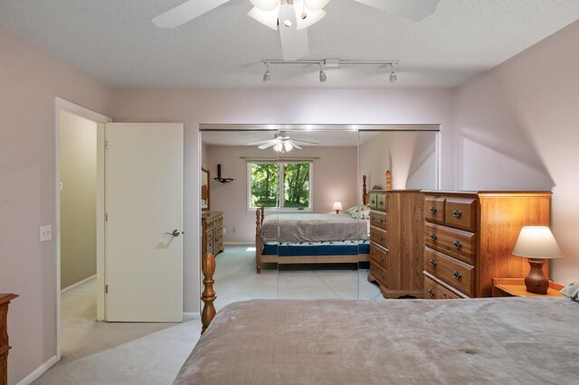 17915 17th Ave N, Plymouth, MN 55447 - carpeted bedroom featuring ceiling fan, track lighting, baseboards, and a textured ceiling