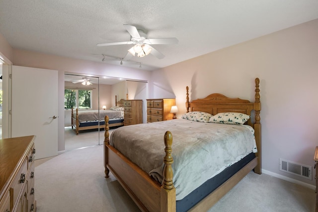 17915 17th Ave N, Plymouth, MN 55447 - bedroom with light colored carpet, track lighting, ceiling fan, and a textured ceiling