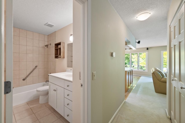 17915 17th Ave N, Plymouth, MN 55447 - full bath featuring a textured ceiling, vanity, toilet, shower / bath combination, and tile patterned floors