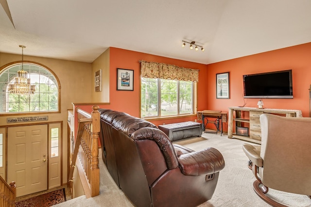 28610 Bay Shore Dr NW, Isanti, MN 55040 - living room featuring carpet flooring, a chandelier, plenty of natural light, track lighting, and lofted ceiling
