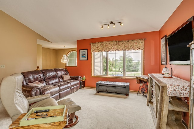 28610 Bay Shore Dr NW, Isanti, MN 55040 - carpeted living room featuring a chandelier, baseboards, and lofted ceiling