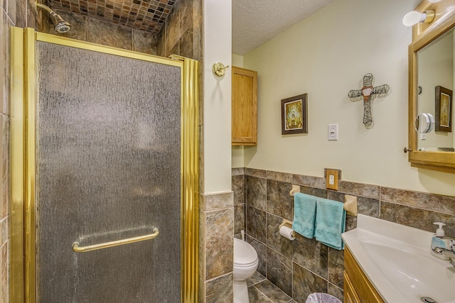 28610 Bay Shore Dr NW, Isanti, MN 55040 - bathroom with tile walls, a shower stall, vanity, toilet, and wainscoting