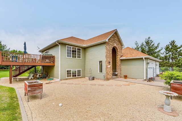28610 Bay Shore Dr NW, Isanti, MN 55040 - rear view of property featuring a wooden deck, stairs, and roof with shingles