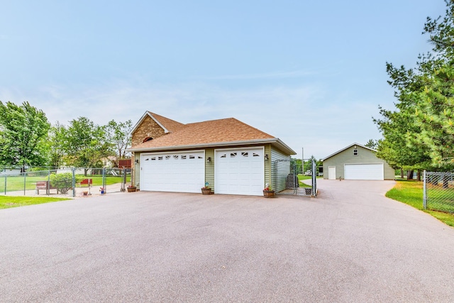 28610 Bay Shore Dr NW, Isanti, MN 55040 - view of front of house featuring a detached garage, an outdoor structure, and a shingled roof