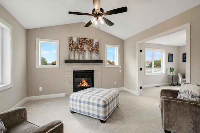 17769 Hoover St NW, Elk River, MN 55330 - carpeted living room featuring ceiling fan, a tiled fireplace, baseboards, and vaulted ceiling