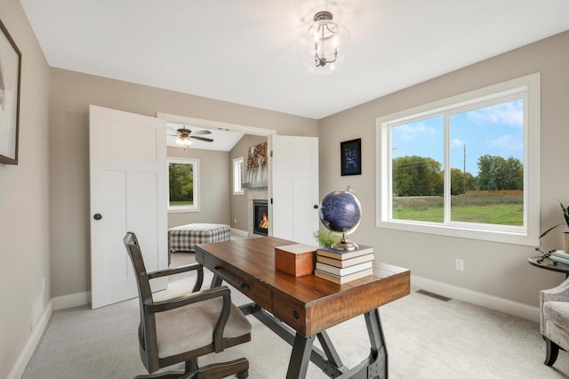 17769 Hoover St NW, Elk River, MN 55330 - home office featuring baseboards, a fireplace, and light colored carpet