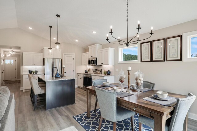 17769 Hoover St NW, Elk River, MN 55330 - dining area with a chandelier, lofted ceiling, light wood-style floors, and recessed lighting