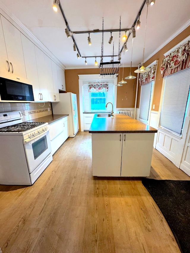 1609 11th Ave S, Minneapolis, MN 55404 - kitchen with white appliances, a sink, rail lighting, white cabinetry, and crown molding