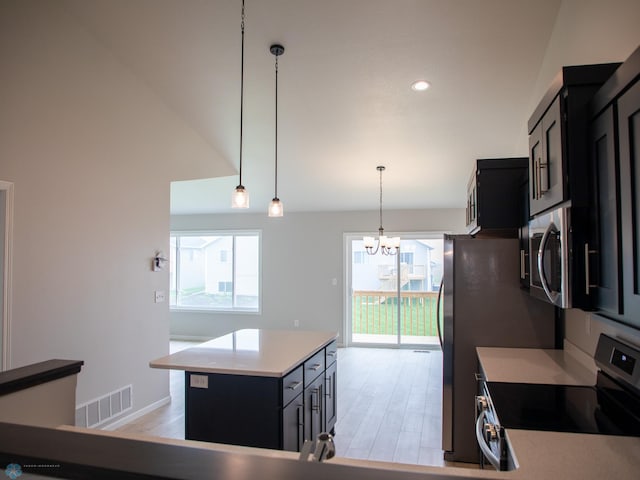 6325 83rd Ave S, Horace, ND 58047 - kitchen with appliances with stainless steel finishes, dark cabinets, a chandelier, light wood-type flooring, and recessed lighting