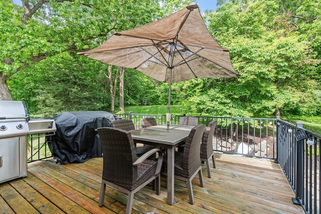 8150 Wildwood Rd, Laketown Twp, MN 55387 - wooden terrace featuring outdoor dining area, area for grilling, and view of scattered trees