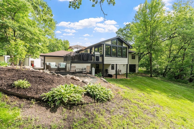 8150 Wildwood Rd, Laketown Twp, MN 55387 - rear view of house featuring a deck, an outdoor living space, a lawn, a patio area, and a sunroom