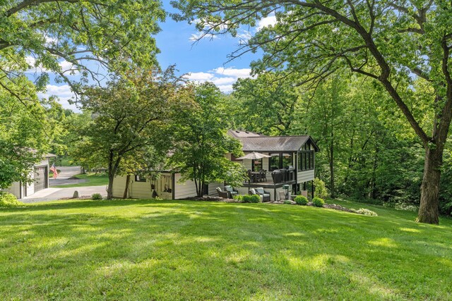 8150 Wildwood Rd, Laketown Twp, MN 55387 - view of green lawn featuring a sunroom and a garage