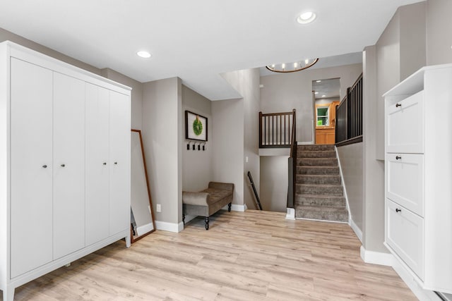 8150 Wildwood Rd, Laketown Twp, MN 55387 - sitting room with light wood-type flooring, baseboards, stairway, recessed lighting, and a chandelier