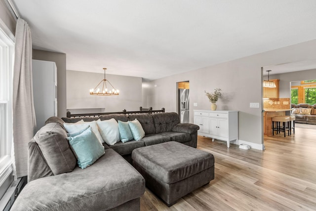 8150 Wildwood Rd, Laketown Twp, MN 55387 - living area featuring a chandelier and light wood-type flooring