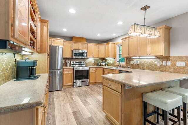 8150 Wildwood Rd, Laketown Twp, MN 55387 - kitchen with stainless steel appliances, a sink, a peninsula, light brown cabinetry, and recessed lighting