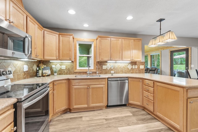 8150 Wildwood Rd, Laketown Twp, MN 55387 - kitchen with stainless steel appliances, a sink, light brown cabinetry, a peninsula, and recessed lighting