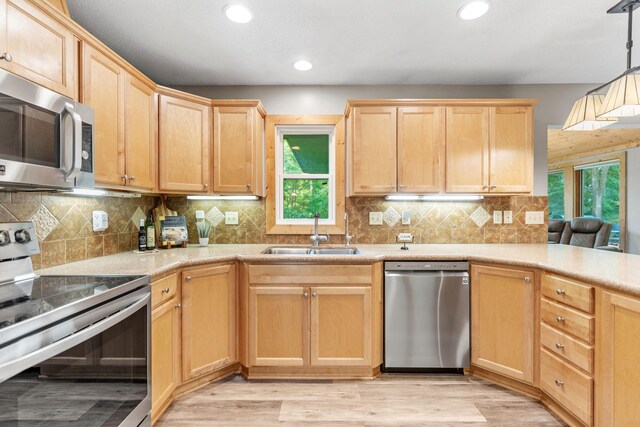 8150 Wildwood Rd, Laketown Twp, MN 55387 - kitchen with stainless steel appliances, a sink, light brown cabinetry, healthy amount of natural light, and recessed lighting