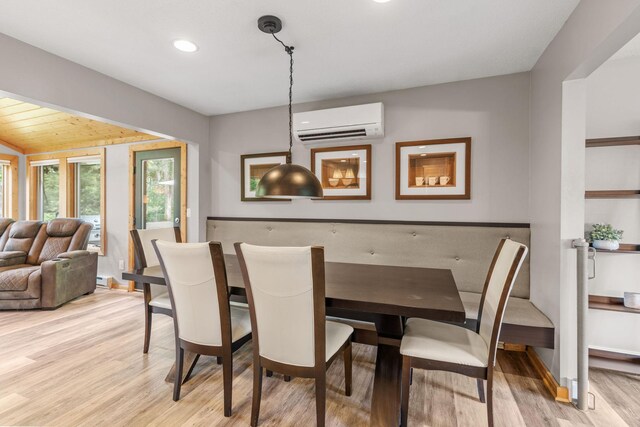 8150 Wildwood Rd, Laketown Twp, MN 55387 - dining area featuring an AC wall unit, light wood-style floors, recessed lighting, and baseboards