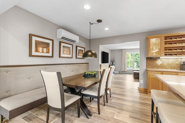 8150 Wildwood Rd, Laketown Twp, MN 55387 - dining room with an AC wall unit, light wood-type flooring, recessed lighting, and a baseboard heating unit