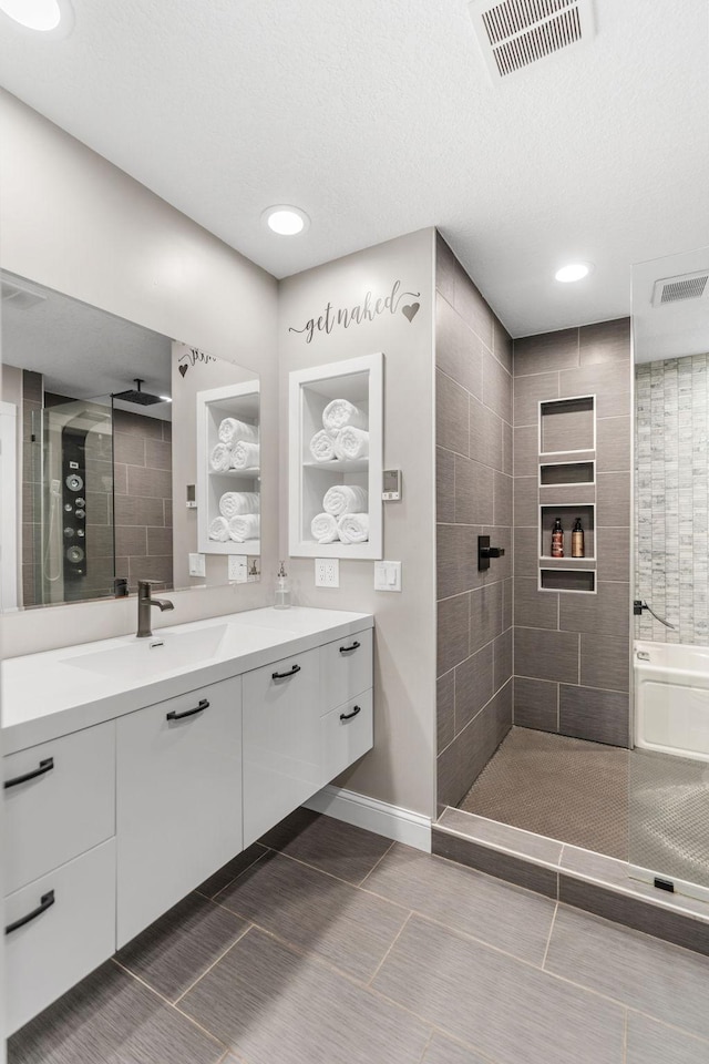 8150 Wildwood Rd, Laketown Twp, MN 55387 - full bath featuring vanity, tiled shower, tile patterned floors, recessed lighting, and baseboards