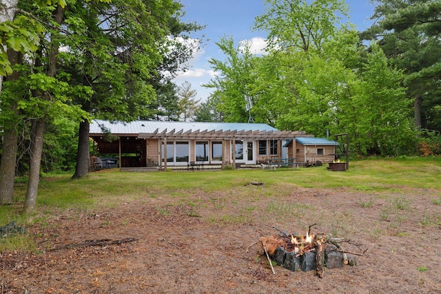 218 9 1/4 Ave, Turtle Lake, WI 54004 - view of front of property featuring an outdoor fire pit and metal roof