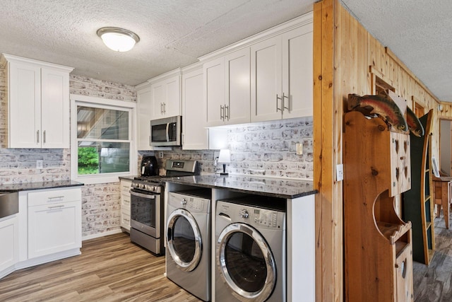 218 9 1/4 Ave, Turtle Lake, WI 54004 - washroom featuring washing machine and clothes dryer, a textured ceiling, and light wood finished floors