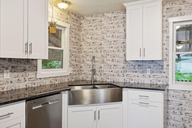 218 9 1/4 Ave, Turtle Lake, WI 54004 - kitchen featuring dishwasher, a sink, white cabinets, dark stone counters, and a textured ceiling