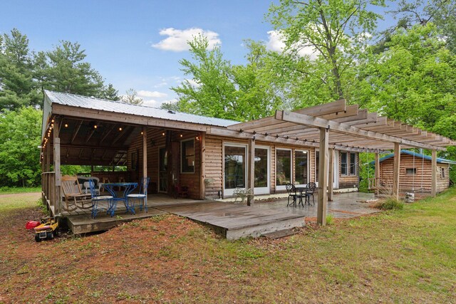 218 9 1/4 Ave, Turtle Lake, WI 54004 - back of property featuring a pergola, a wooden deck, an outdoor structure, and metal roof