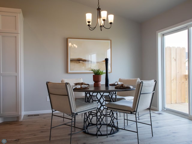 6321 83rd Ave S, Horace, ND 58047 - dining room with a chandelier, light wood-type flooring, and baseboards