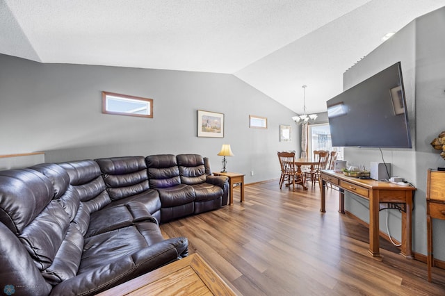 1095 Parkway Ln, West Fargo, ND 58078 - living room with a chandelier, vaulted ceiling, wood finished floors, and baseboards