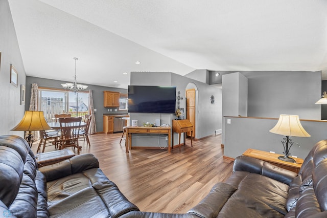 1095 Parkway Ln, West Fargo, ND 58078 - living area with light wood finished floors, a chandelier, arched walkways, baseboards, and recessed lighting