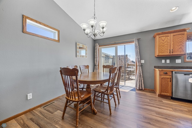 1095 Parkway Ln, West Fargo, ND 58078 - dining room featuring baseboards, healthy amount of natural light, a chandelier, and light wood-type flooring