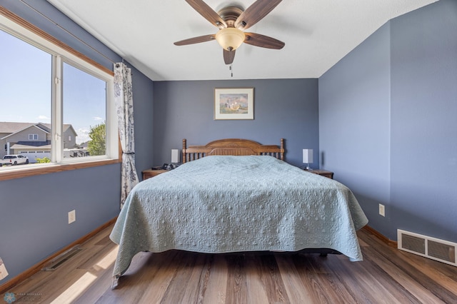 1095 Parkway Ln, West Fargo, ND 58078 - bedroom with wood finished floors, baseboards, and ceiling fan