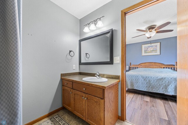 1095 Parkway Ln, West Fargo, ND 58078 - ensuite bathroom featuring vanity, a ceiling fan, and baseboards