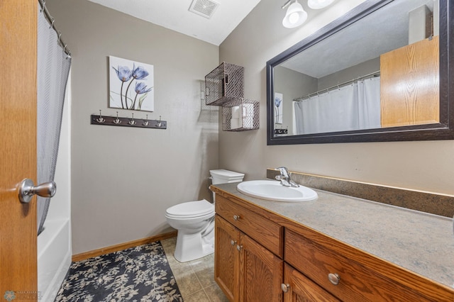 1095 Parkway Ln, West Fargo, ND 58078 - full bathroom with vanity, toilet, tile patterned floors, and baseboards