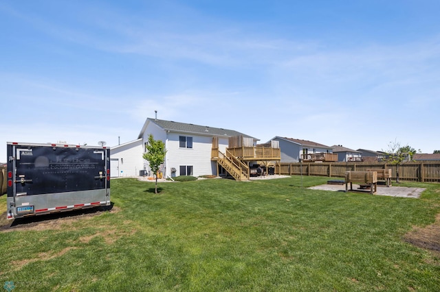 1095 Parkway Ln, West Fargo, ND 58078 - view of yard featuring a wooden deck, stairs, and a patio