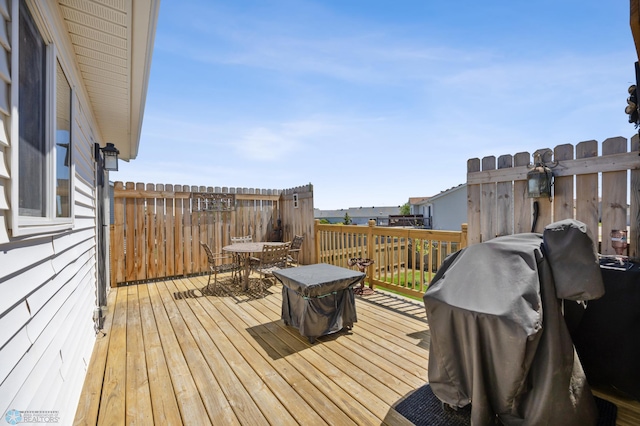 1095 Parkway Ln, West Fargo, ND 58078 - deck featuring outdoor dining space and a grill