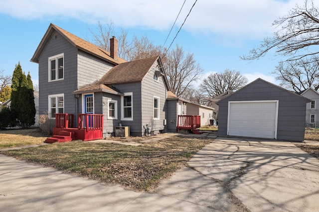 1010 8th Ave NE, Austin, MN 55912 - view of side of home featuring an outdoor structure, a chimney, concrete driveway, a detached garage, and roof with shingles