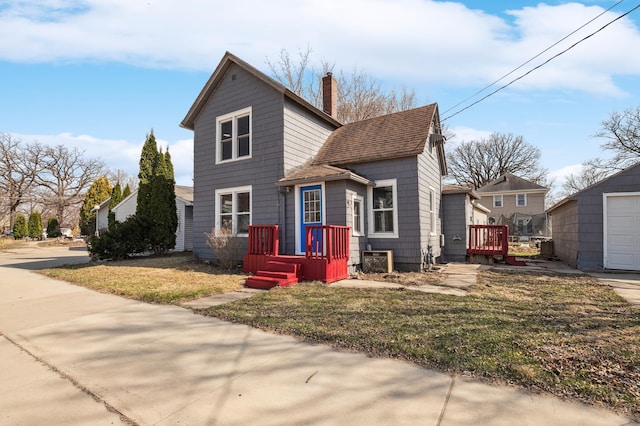1010 8th Ave NE, Austin, MN 55912 - traditional-style home with a chimney, a front lawn, and a shingled roof