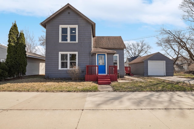 1010 8th Ave NE, Austin, MN 55912 - traditional home with a garage, an outdoor structure, driveway, roof with shingles, and a front lawn