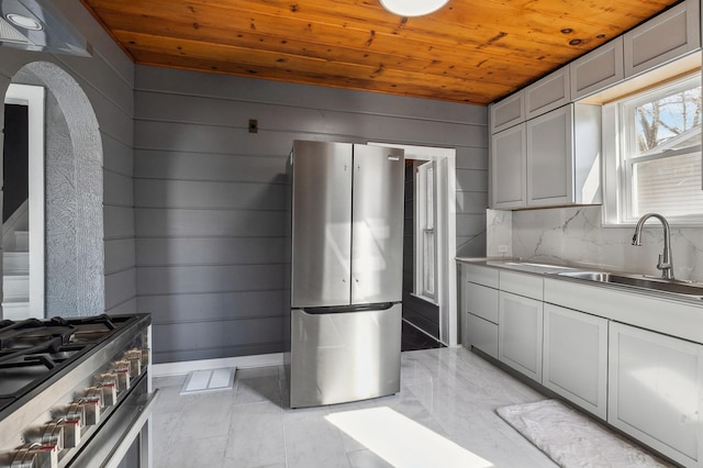 1010 8th Ave NE, Austin, MN 55912 - kitchen with wood ceiling, appliances with stainless steel finishes, stainless steel countertops, a sink, and arched walkways
