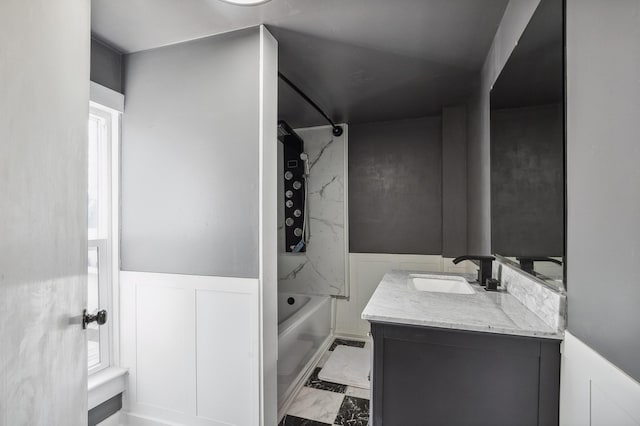 1010 8th Ave NE, Austin, MN 55912 - full bath with washtub / shower combination, vanity, marble look tile flooring, and wainscoting