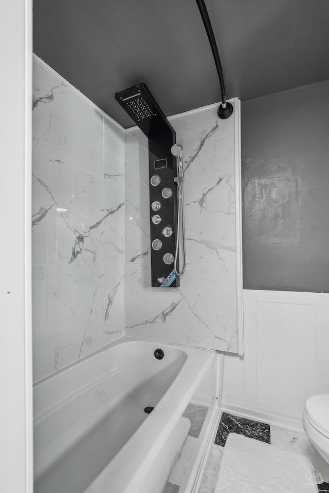 1010 8th Ave NE, Austin, MN 55912 - bathroom with washtub / shower combination, toilet, and marble finish flooring