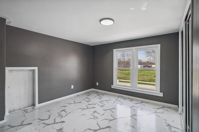 1010 8th Ave NE, Austin, MN 55912 - spare room with baseboards and marble finish flooring