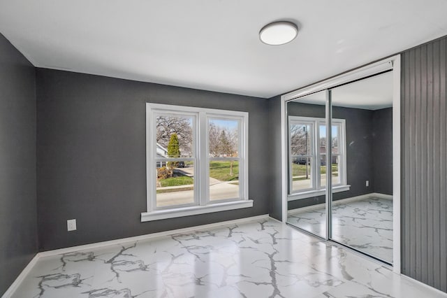1010 8th Ave NE, Austin, MN 55912 - empty room with marble finish floors, healthy amount of natural light, and baseboards