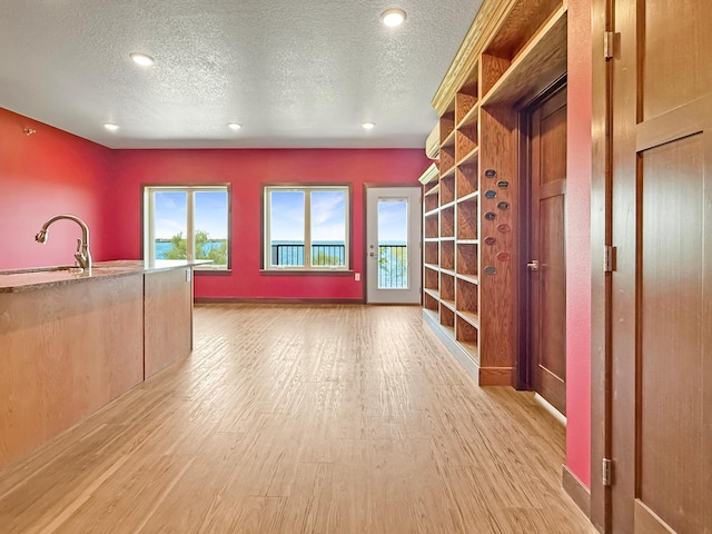 715 Lake Shore Dr NE Unit 214, Bemidji, MN 56601 - interior space featuring a sink, light wood-style floors, a textured ceiling, and recessed lighting