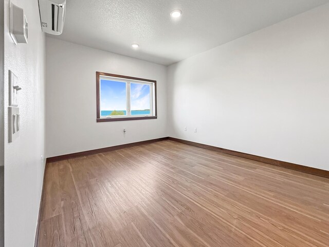715 Lake Shore Dr NE Unit 214, Bemidji, MN 56601 - empty room with wood finished floors, baseboards, and recessed lighting