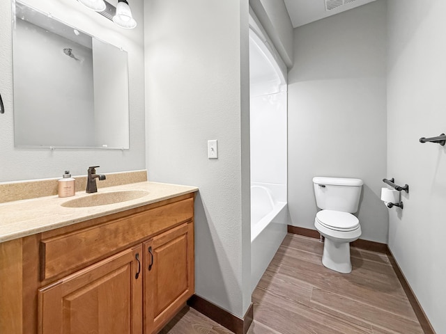 715 Lake Shore Dr NE Unit 214, Bemidji, MN 56601 - full bath with toilet, vanity, wood finished floors, and baseboards