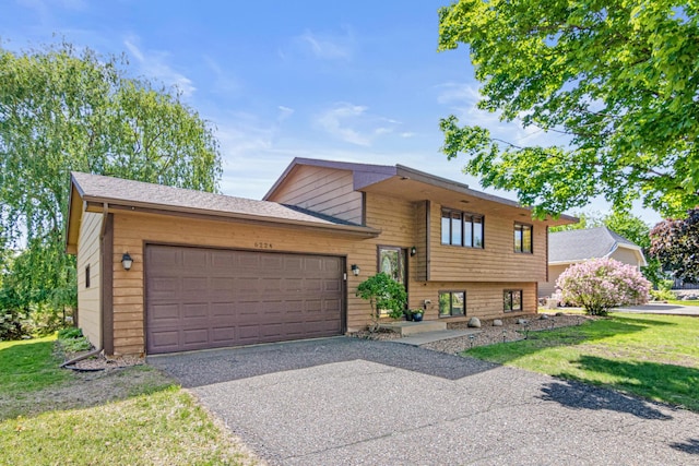 6224 Nathan Ln N, Maple Grove, MN 55369 - tri-level home with a garage, driveway, and a front lawn